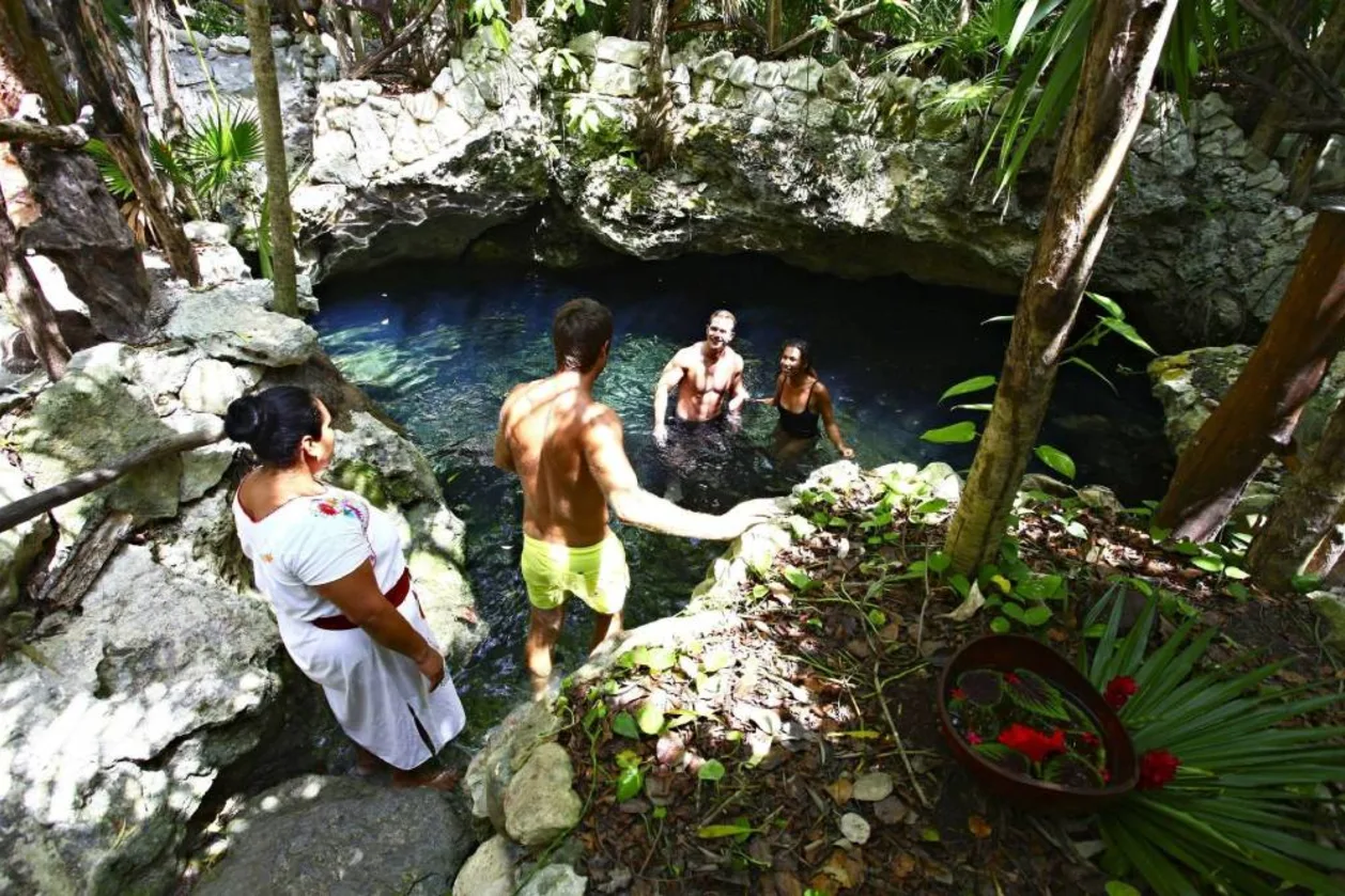 Guests in cenote at Sandos Caracol Eco Resort